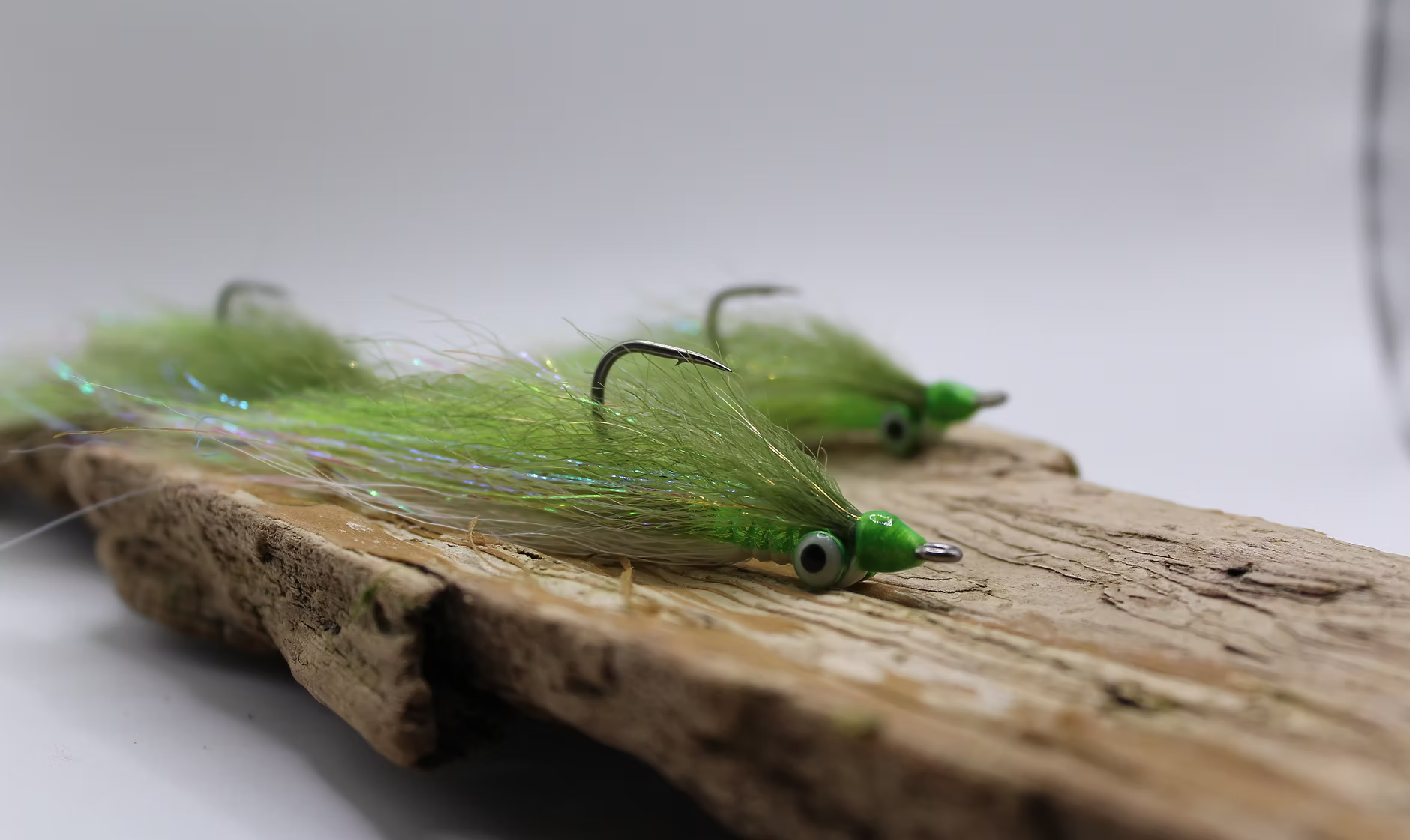 Hand-tied bucktail jigs on driftwood